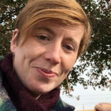 headshot of white woman standing outside, with short blond hair