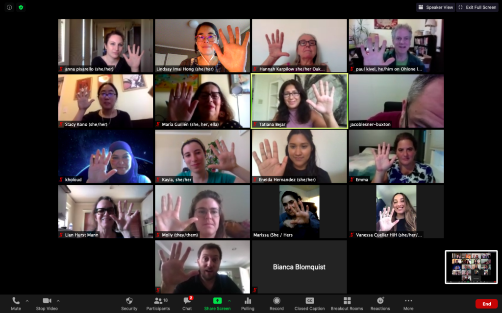 Grid of people holding up zoom call during zoom meeting