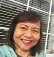 Woman smiling in front of a window