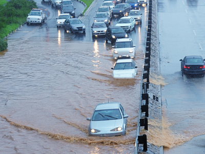 Cars on a flooded road driving in two separate directions