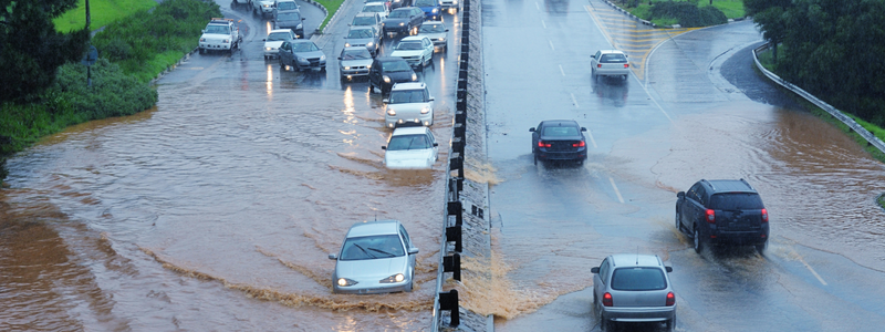 Cars on a flooded road driving in two separate directions