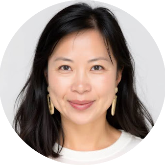 Headshot of Janny Chang, an asian woman with long black hair and gold dangling earrings looking into the camera.