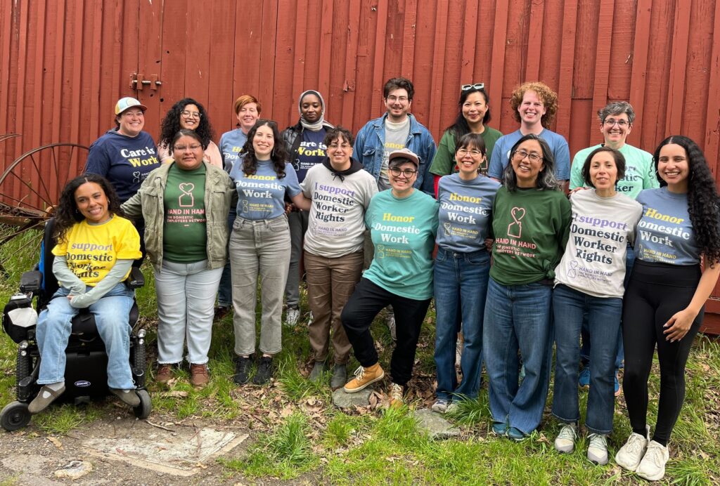 A group of people stand together in front of a wooden building